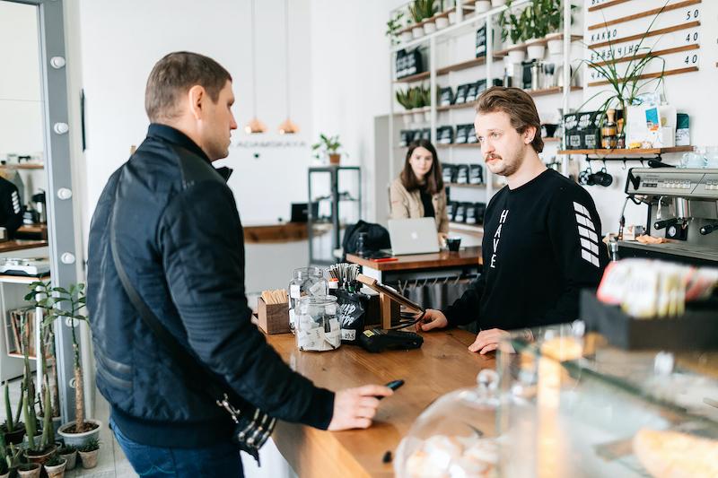 barista takes an order in a coffee shop